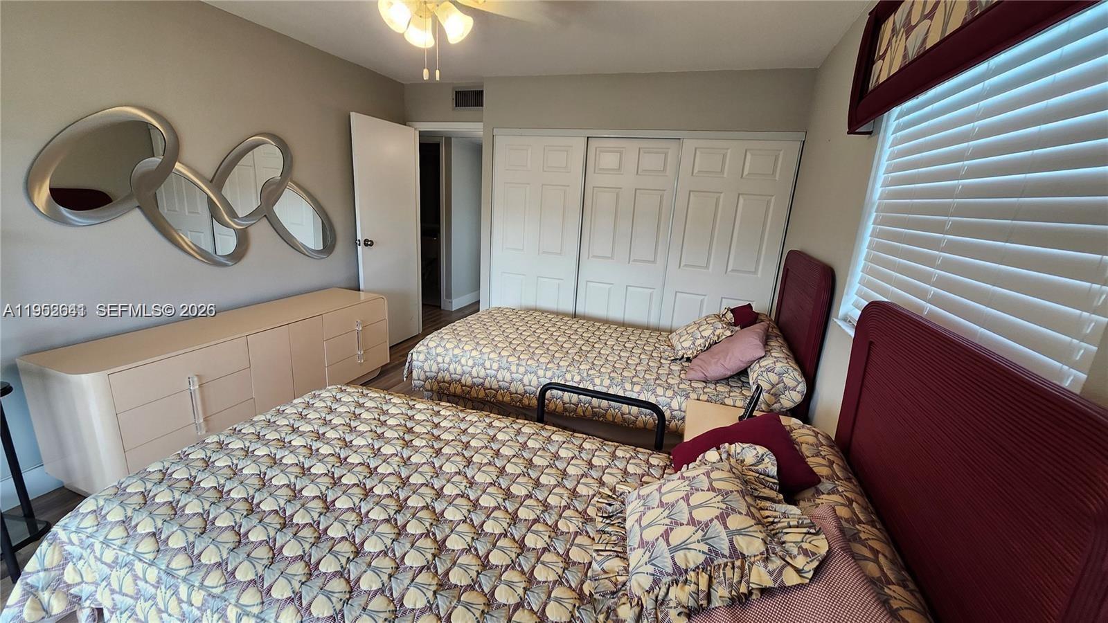 756 Flanders P Delray Beach, Unit 756 Delray Beach, FL 33484 - Photo 13 of 46 a bedroom with a bed and a chandelier