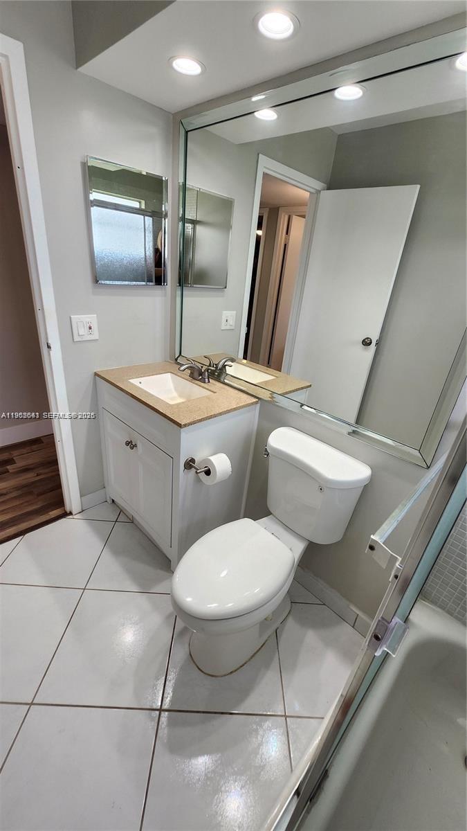 756 Flanders P Delray Beach, Unit 756 Delray Beach, FL 33484 - Photo 20 of 46 a bathroom with a toilet sink and mirror