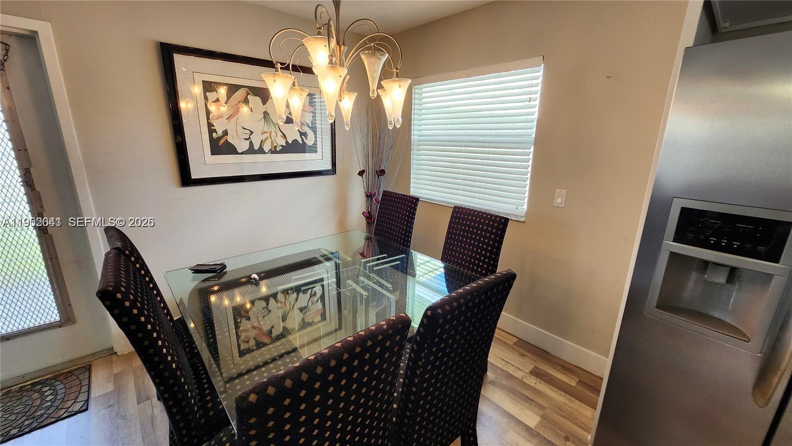 756 Flanders P Delray Beach, Unit 756 Delray Beach, FL 33484 - Photo 7 of 46 a view of a dining room with furniture window and wooden floor