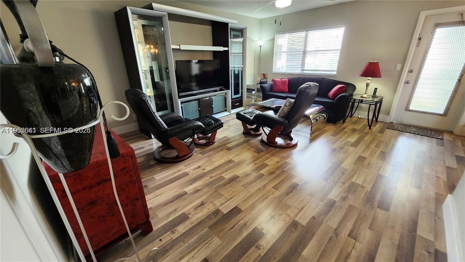 756 Flanders P Delray Beach, Unit 756 Delray Beach, FL 33484 - Photo 8 of 46 a living room with furniture and a flat screen tv