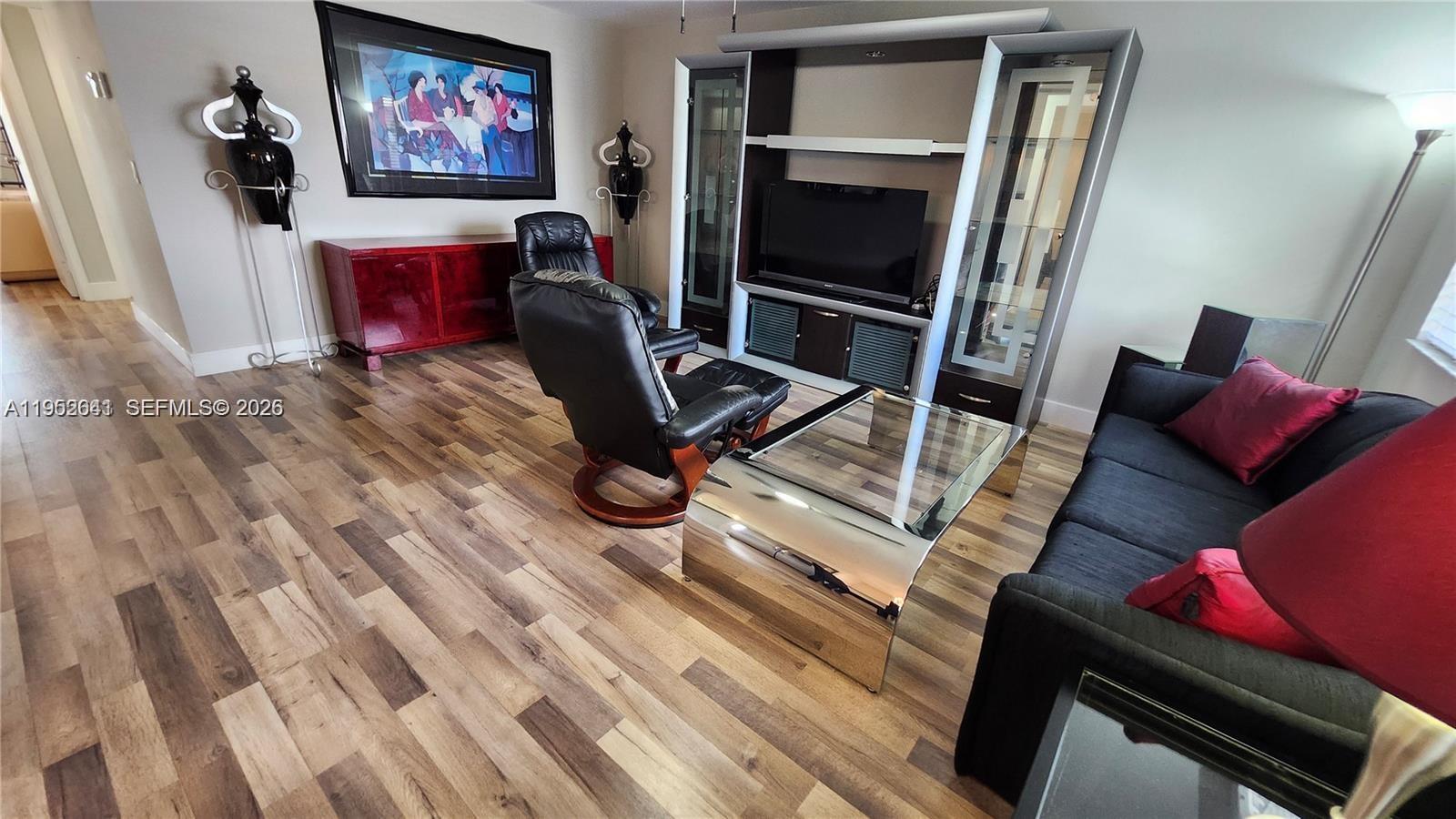 756 Flanders P Delray Beach, Unit 756 Delray Beach, FL 33484 - Photo 9 of 46 a living room with furniture and a flat screen tv