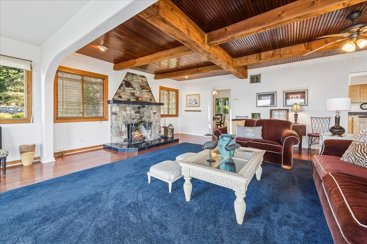 712 Regner Road McHenry, IL 60051 - Photo 12 of 25 a living room with furniture a fireplace and wooden floor