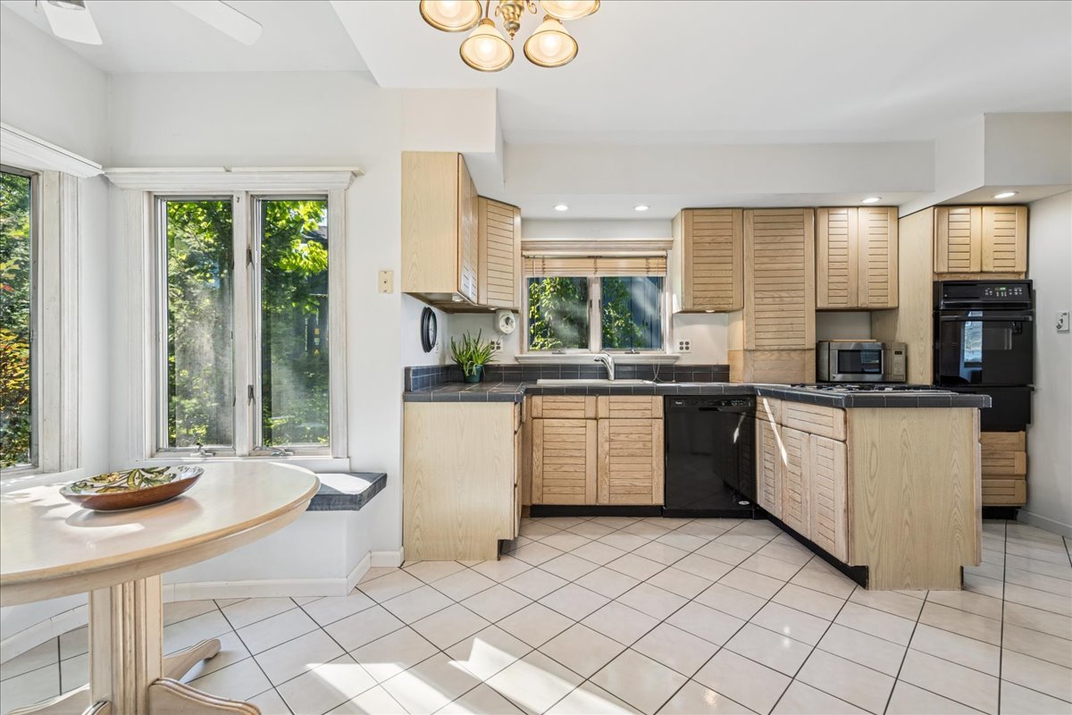 712 Regner Road McHenry, IL 60051 - Photo 13 of 25 a kitchen with a sink cabinets and window