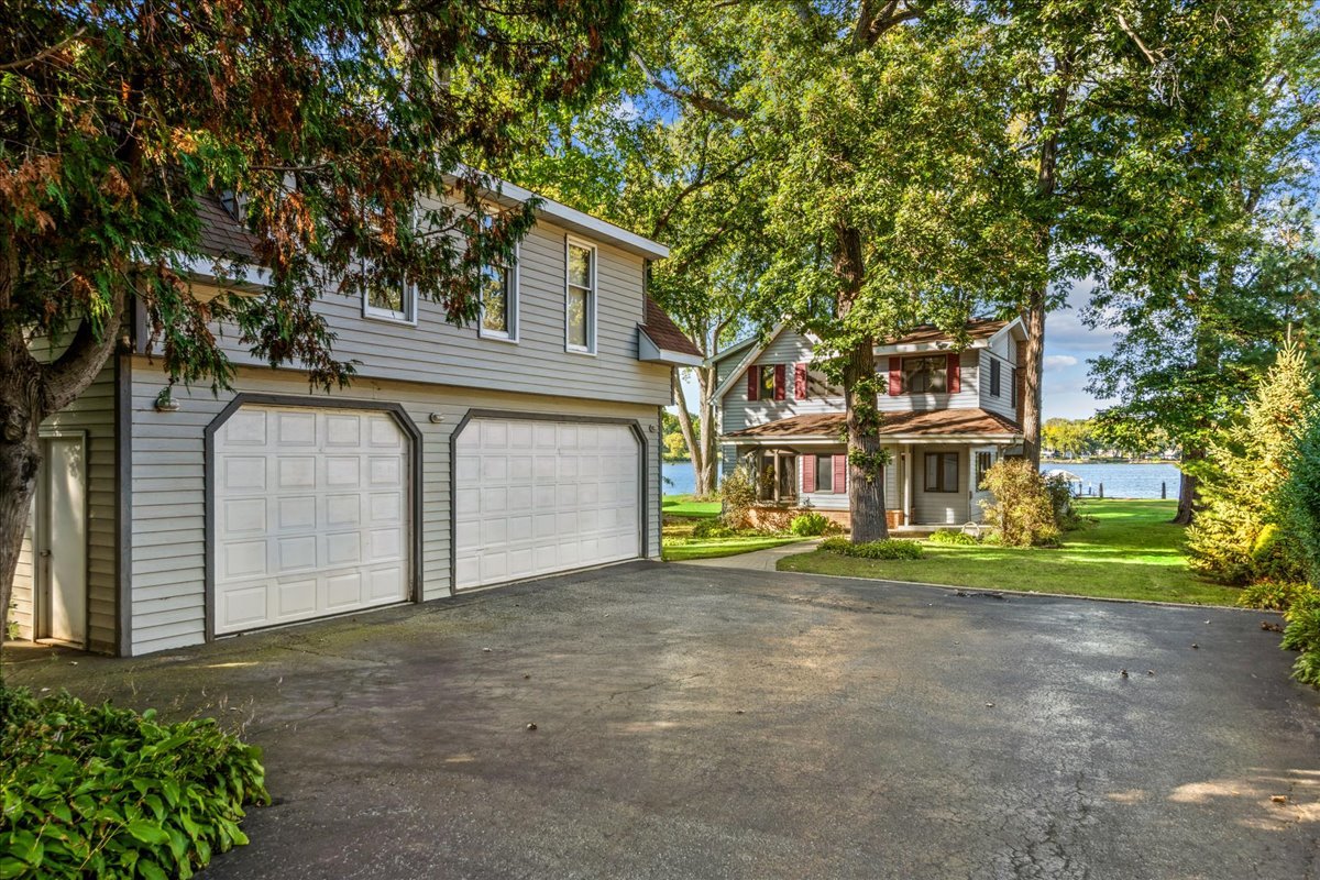 712 Regner Road McHenry, IL 60051 - Photo 2 of 25 a view of a house with a yard and large tree