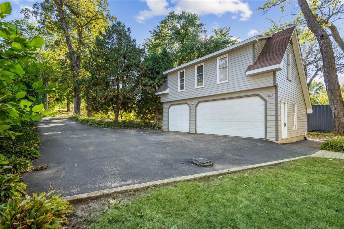 712 Regner Road McHenry, IL 60051 - Photo 24 of 25 a view of a yard with a house and a tree