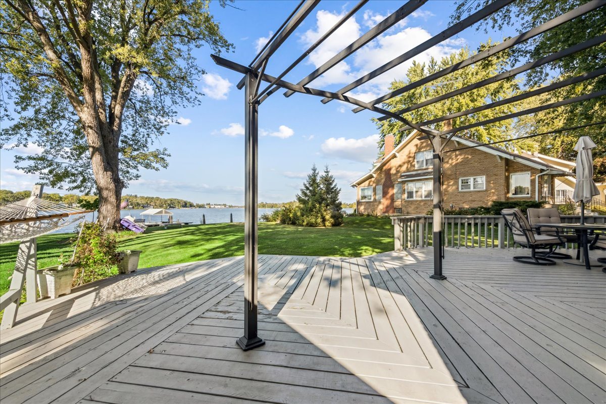 712 Regner Road McHenry, IL 60051 - Photo 6 of 25 a view of a patio with table and chairs and wooden floor