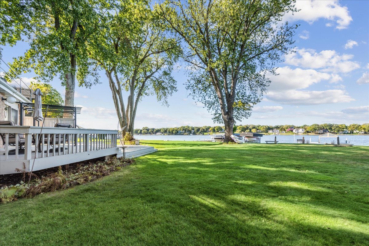 712 Regner Road McHenry, IL 60051 - Photo 7 of 25 a view of a deck with a big yard and large trees