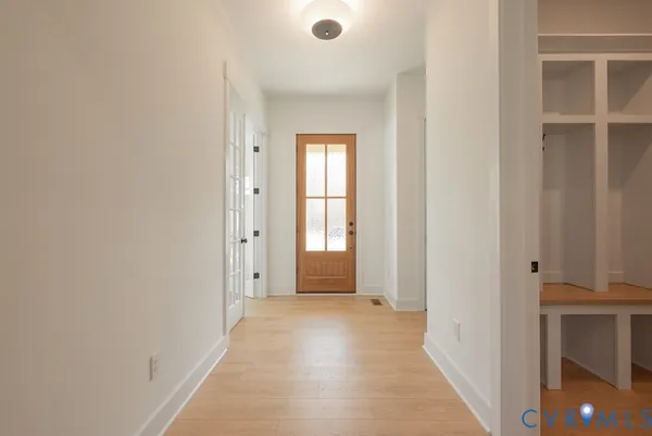 a view of an entryway with wooden floor