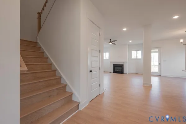 a view of a kitchen with a sink and dishwasher a fireplace with wooden floor