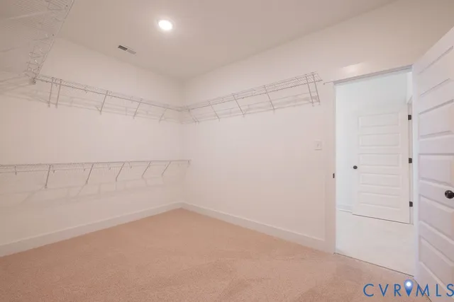 an empty room with a white cabinet and mirrors