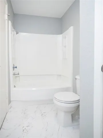a bathroom with a toilet and a bathtub