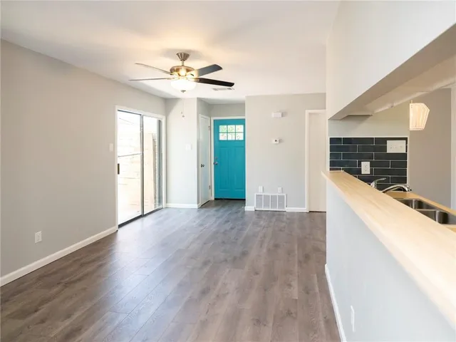 a view of a kitchen with wooden floor and a kitchen