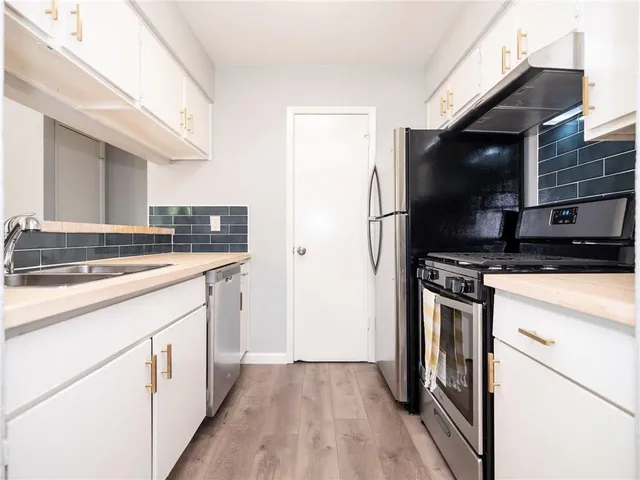 a kitchen with a sink and a refrigerator
