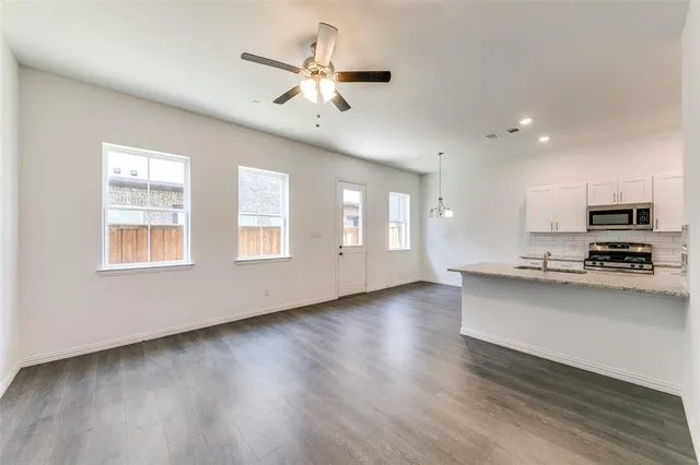a view of kitchen with sink and wooden floor