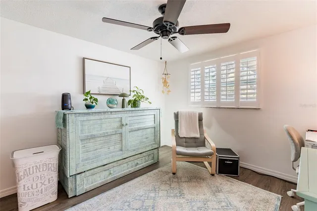 a room with a table chairs and a window