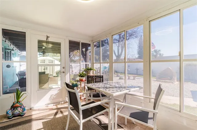a dining room with furniture water view and wooden floor