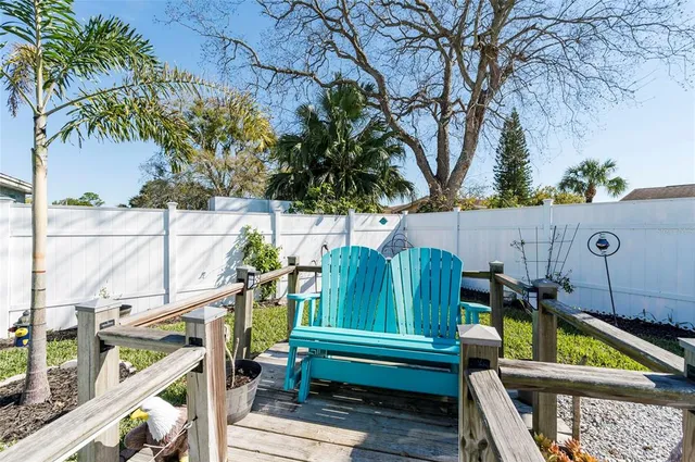 a backyard of a house with barbeque oven and outdoor seating