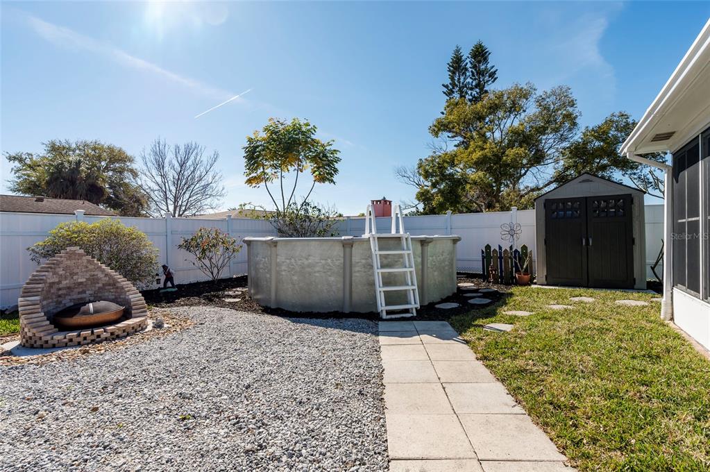 7804 Fox Hollow Drive Port Richey, FL 34668 - Photo 27 of 31 a backyard of a house with barbeque oven and outdoor seating