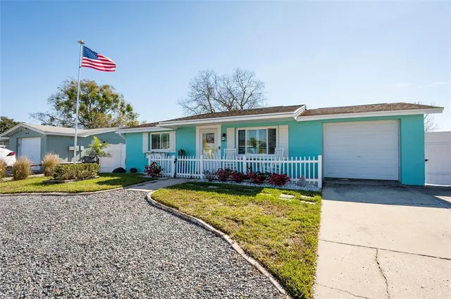 a view of a house with swimming pool and sitting area