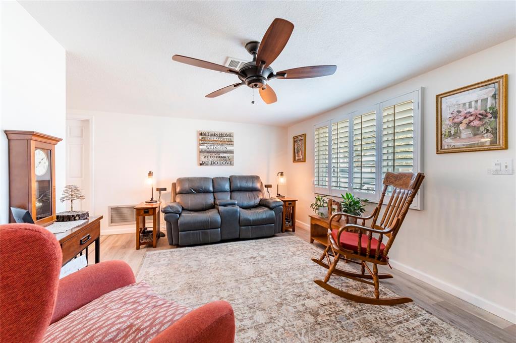 7804 Fox Hollow Drive Port Richey, FL 34668 - Photo 6 of 31 a living room with furniture a window and a ceiling fan