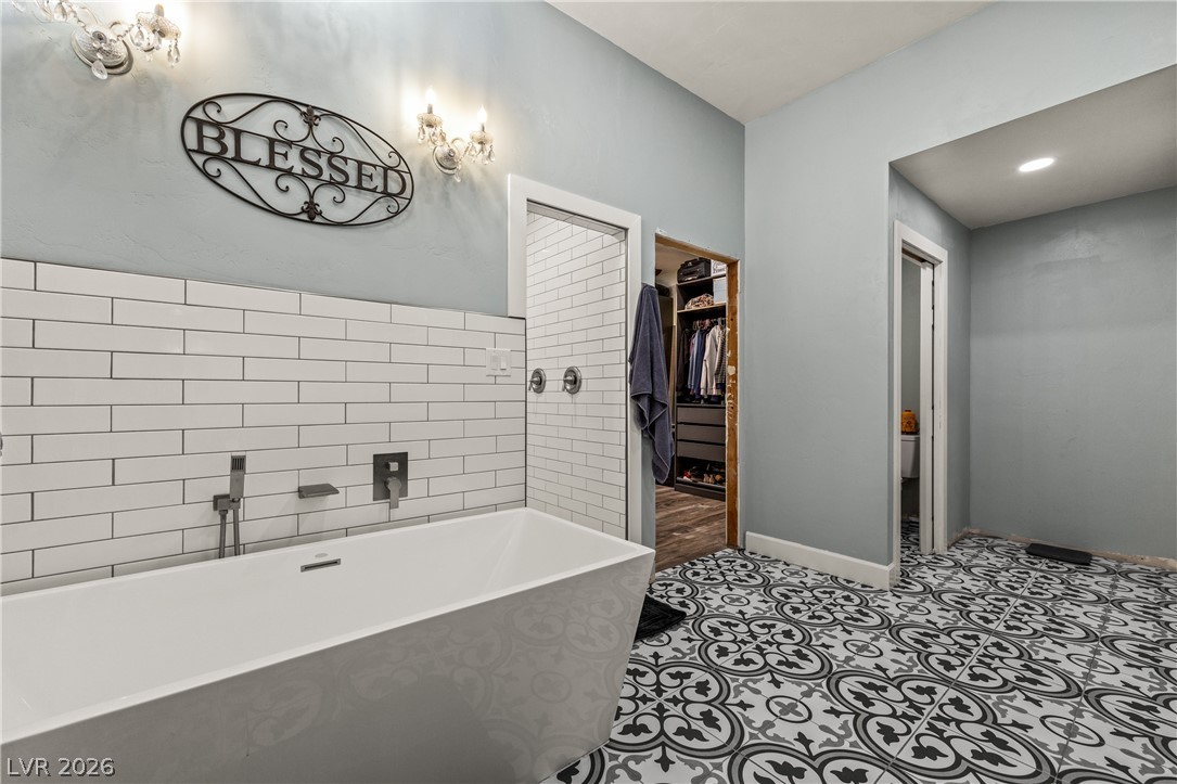 750 Leming Avenue Overton, NV 89040 - Photo 37 of 82 This serene bathroom offers a spacious soaking tub and a walk-in closet for ultimate comfort.