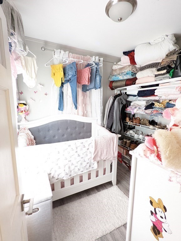 143 London Street, Unit 2 Boston, MA 02128 - Photo 5 of 9 a bedroom with a bed and a painting on the wall