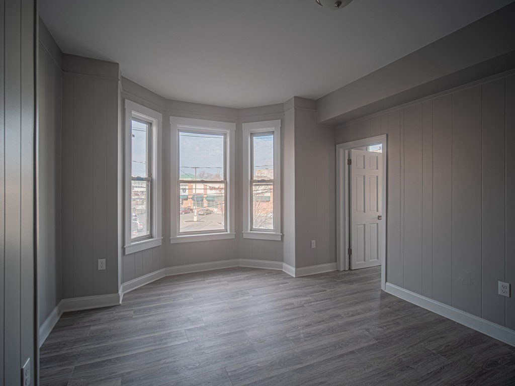 143 London Street, Unit 2 Boston, MA 02128 - Photo 7 of 9 a view of an empty room with wooden floor and window