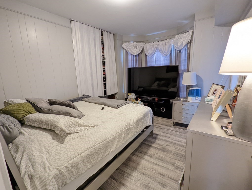 143 London Street, Unit 2 Boston, MA 02128 - Photo 8 of 9 a living room with furniture and a flat screen tv