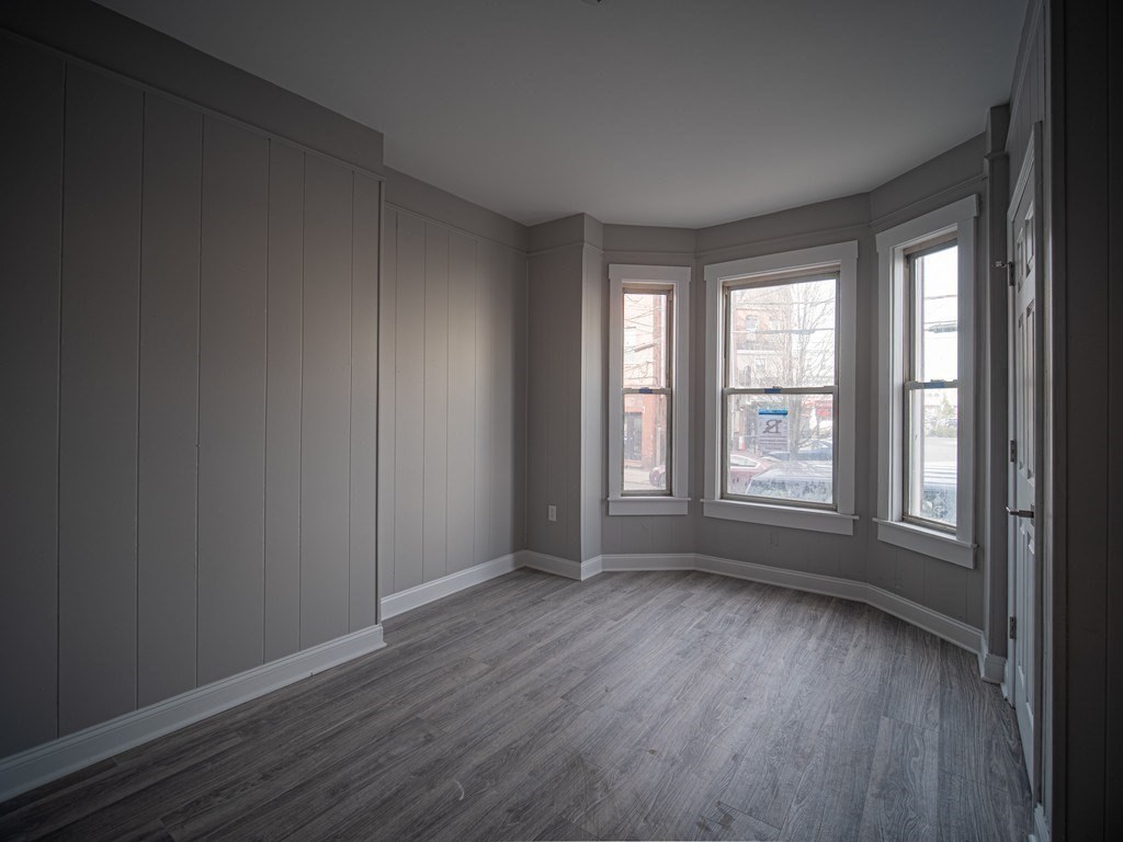 143 London Street, Unit 2 Boston, MA 02128 - Photo 9 of 9 an empty room with wooden floor and windows