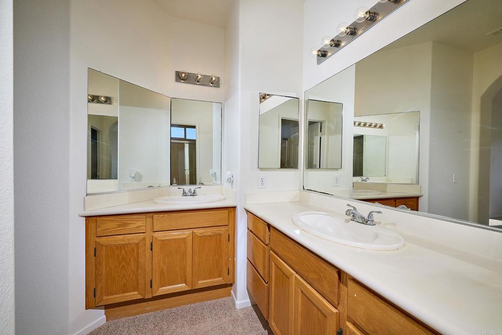 297 Diamante Way Oceanside, CA 92056 - Photo 13 of 28 a bathroom with a sink and a mirror