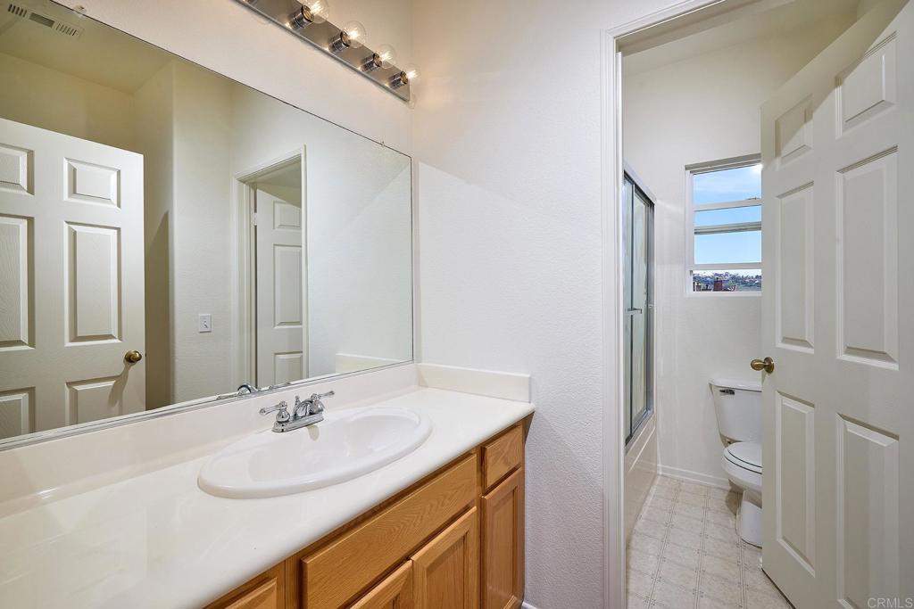 297 Diamante Way Oceanside, CA 92056 - Photo 15 of 28 a bathroom with a sink toilet and shower