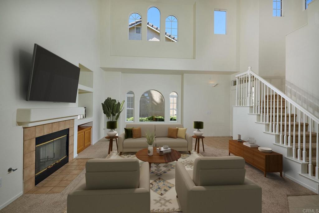 297 Diamante Way Oceanside, CA 92056 - Photo 3 of 28 a living room with furniture a fireplace and a flat screen tv