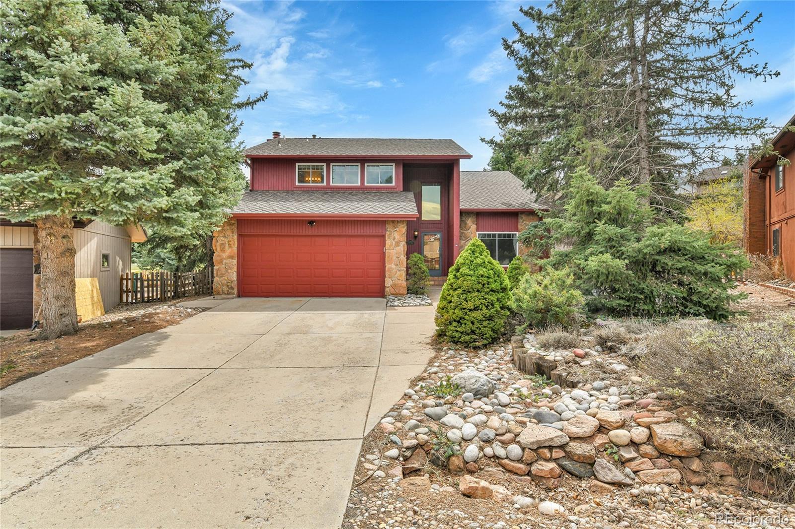 15740 Sandtrap Way Morrison, CO 80465 - Photo 1 of 44 a front view of a house with garden