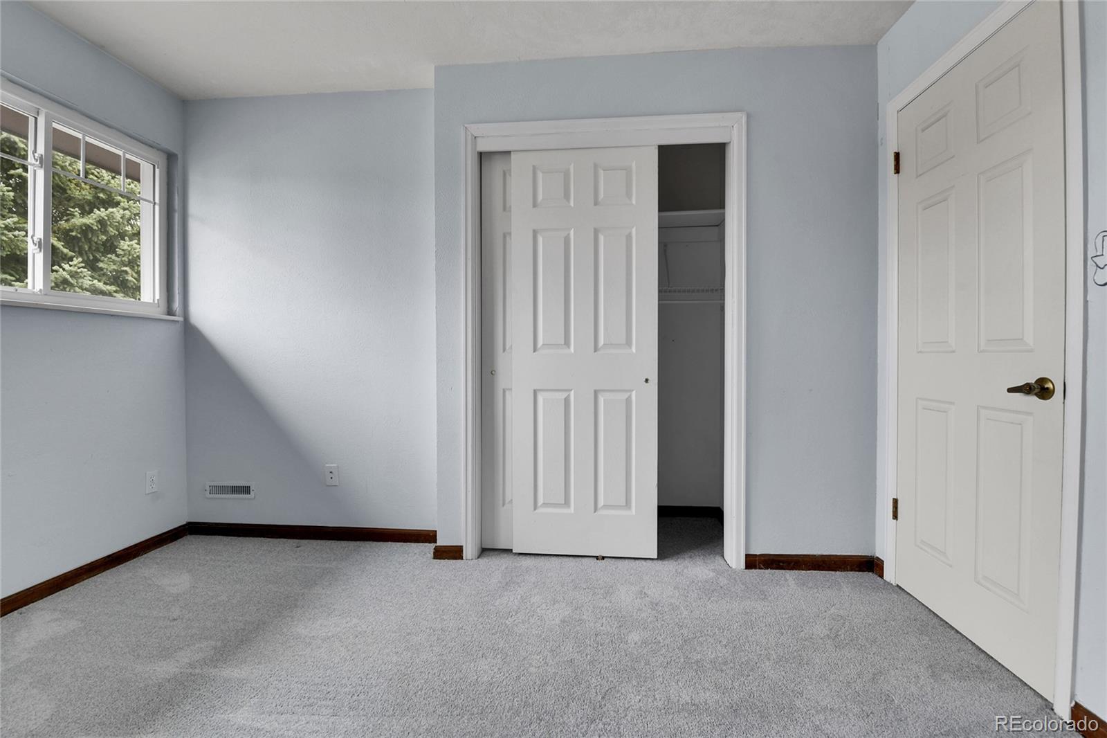 15740 Sandtrap Way Morrison, CO 80465 - Photo 26 of 44 an empty room with windows