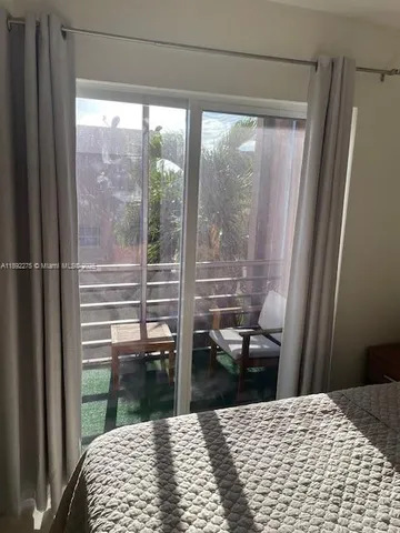 a bedroom with a bed and a ceiling fan