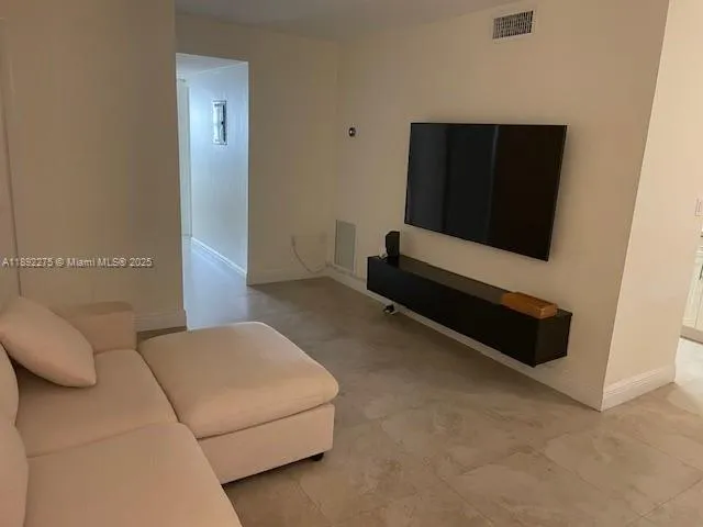 a living room with a couch and a flat screen tv