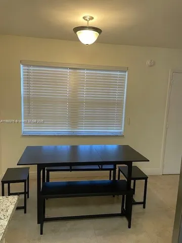 a view of a room with a table and a window