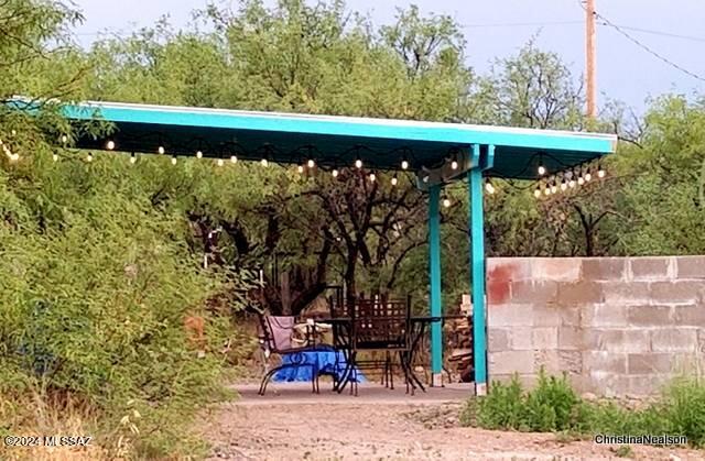 35700 South Cedar Creek Road Arivaca, AZ 85601 - Photo 6 of 44 a view of a patio with table and chairs under an umbrella