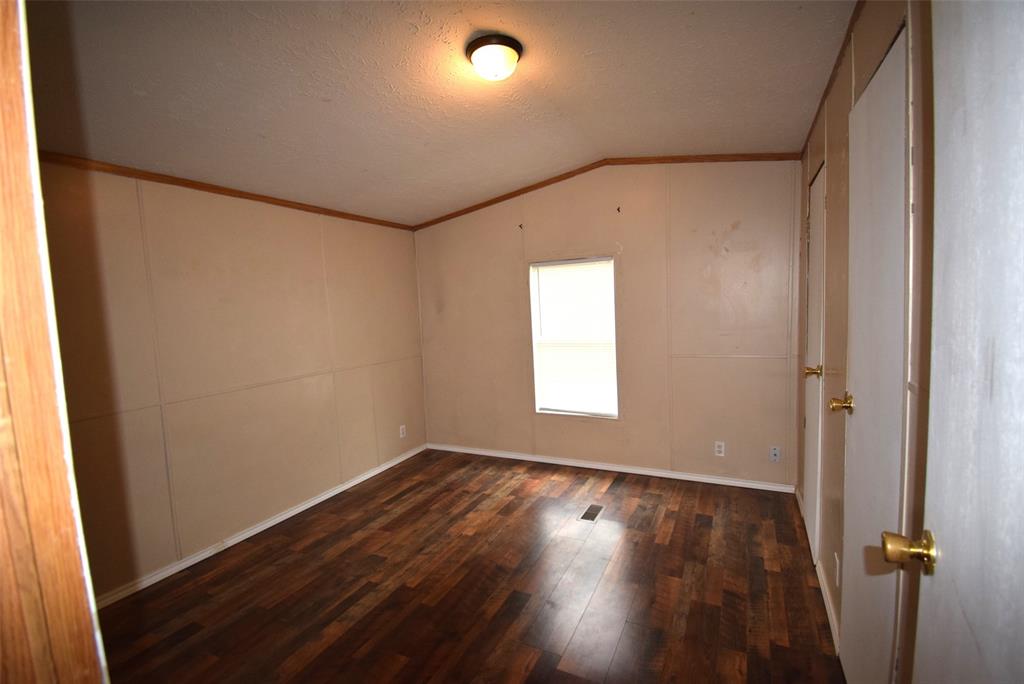 6000 Spring Creek Road, Unit 12 Malakoff, TX 75148 - Photo 8 of 10 an empty room with wooden floor and windows