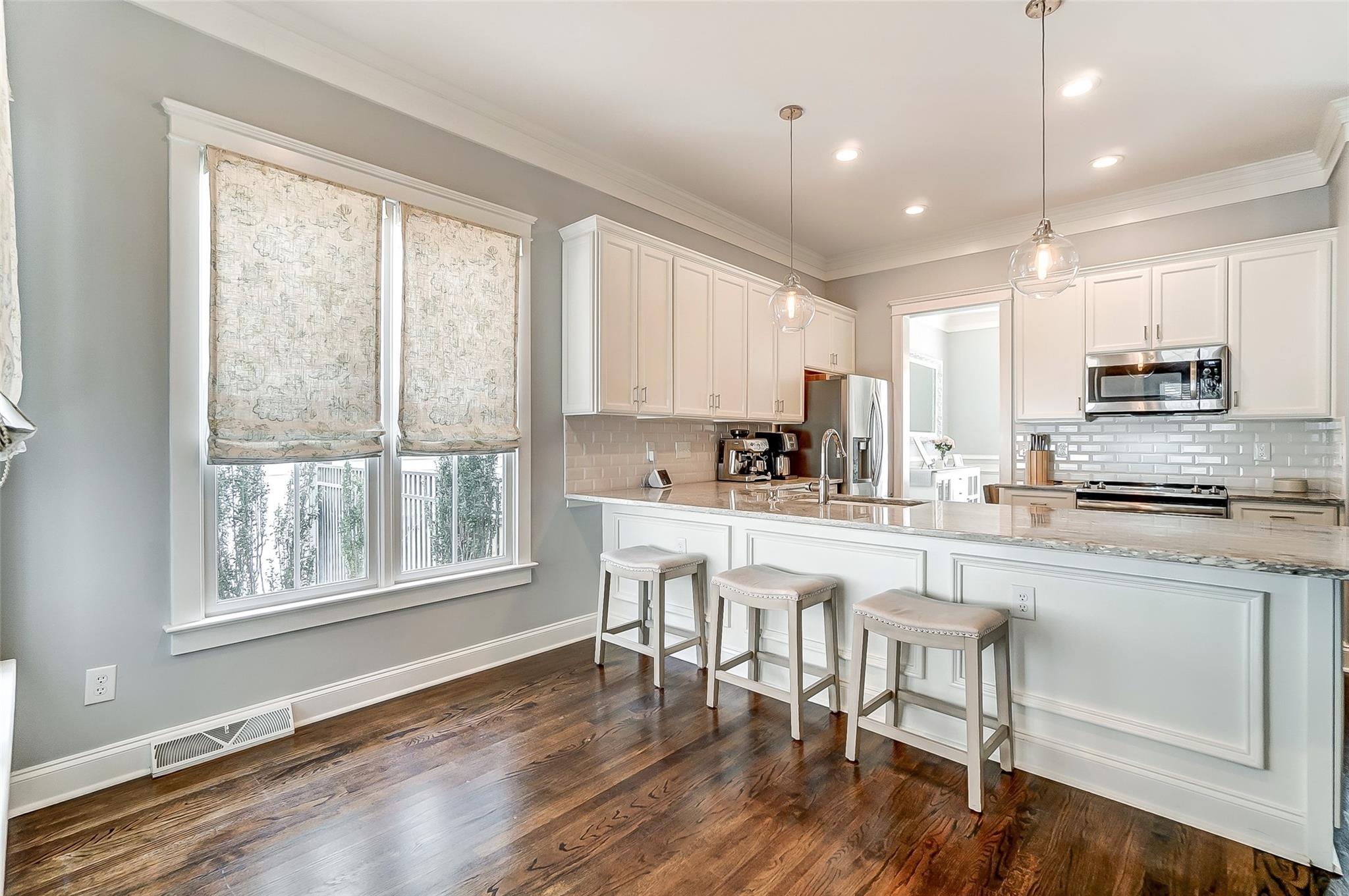 3400 Richard's Crossing Fort Mill, SC 29708 - Photo 13 of 48 a kitchen with stainless steel appliances granite countertop a stove top oven a sink a refrigerator with a dining table and chairs
