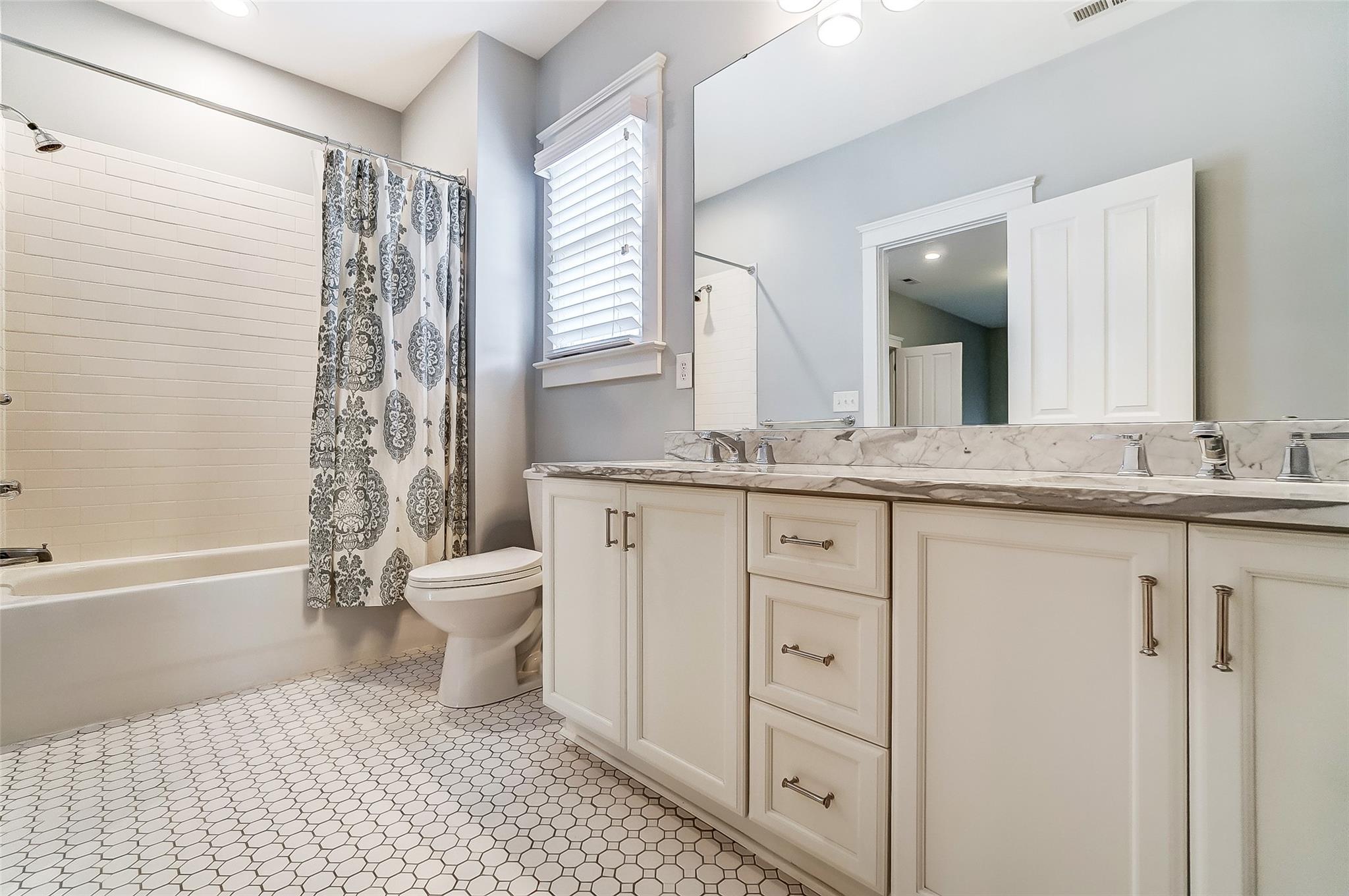 3400 Richard's Crossing Fort Mill, SC 29708 - Photo 31 of 48 a bathroom with a granite countertop sink toilet a large mirror a bathtub and shower