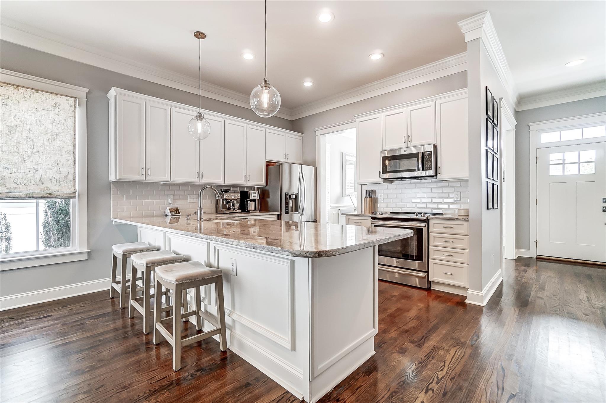 3400 Richard's Crossing Fort Mill, SC 29708 - Photo 7 of 48 a kitchen with kitchen island granite countertop wooden floors and white cabinets
