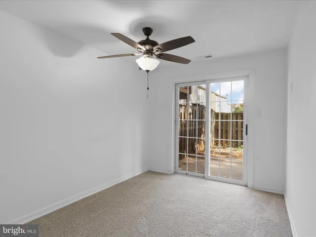 a view of a livingroom with a ceiling fan and window