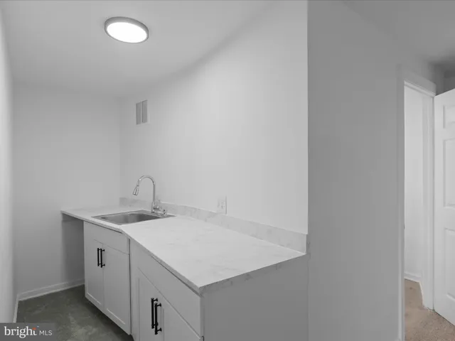 a utility room with cabinets washer and dryer