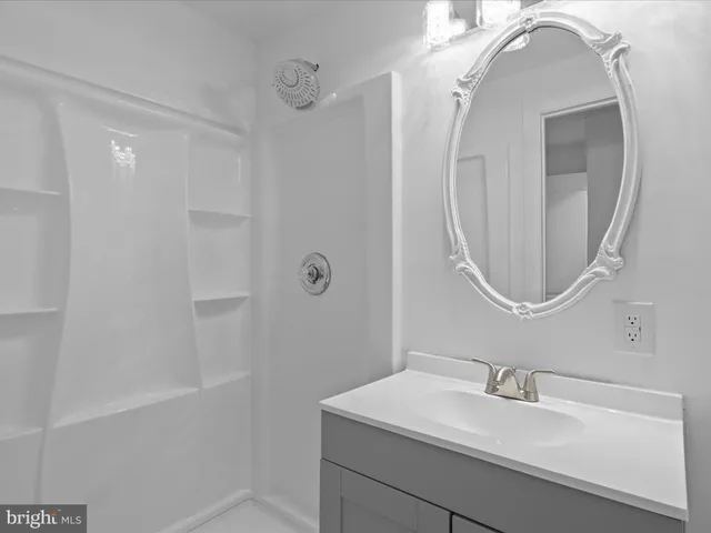 a bathroom with a sink a vanity and a mirror