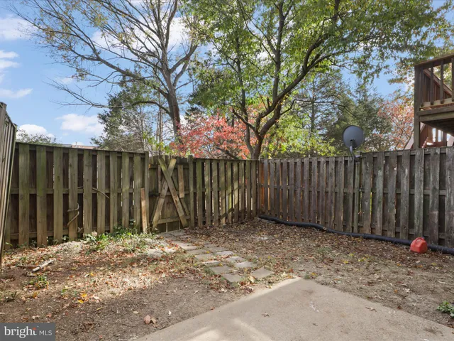 a view of a backyard with wooden fence