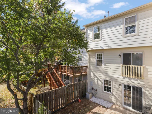 a view of a house with backyard and deck