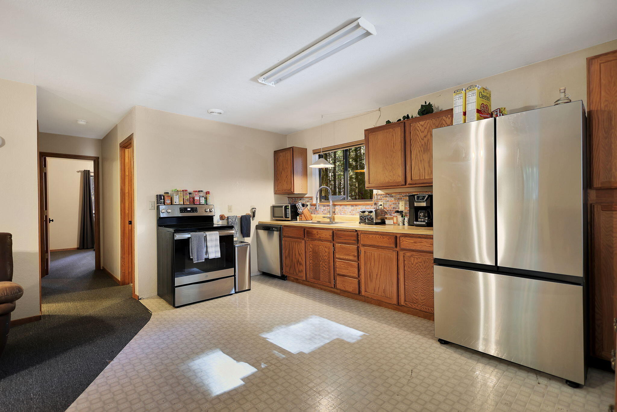 9442 Thatcher Mill Road Shingletown, CA 96088 - Photo 7 of 19 a kitchen with stainless steel appliances and refrigerator