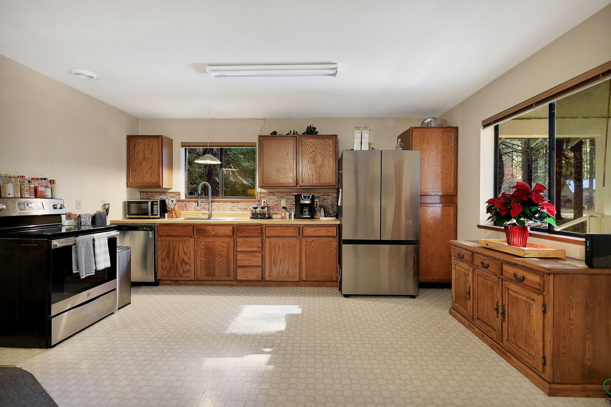 9442 Thatcher Mill Road Shingletown, CA 96088 - Photo 8 of 19 a kitchen with granite countertop a refrigerator stove top oven and sink