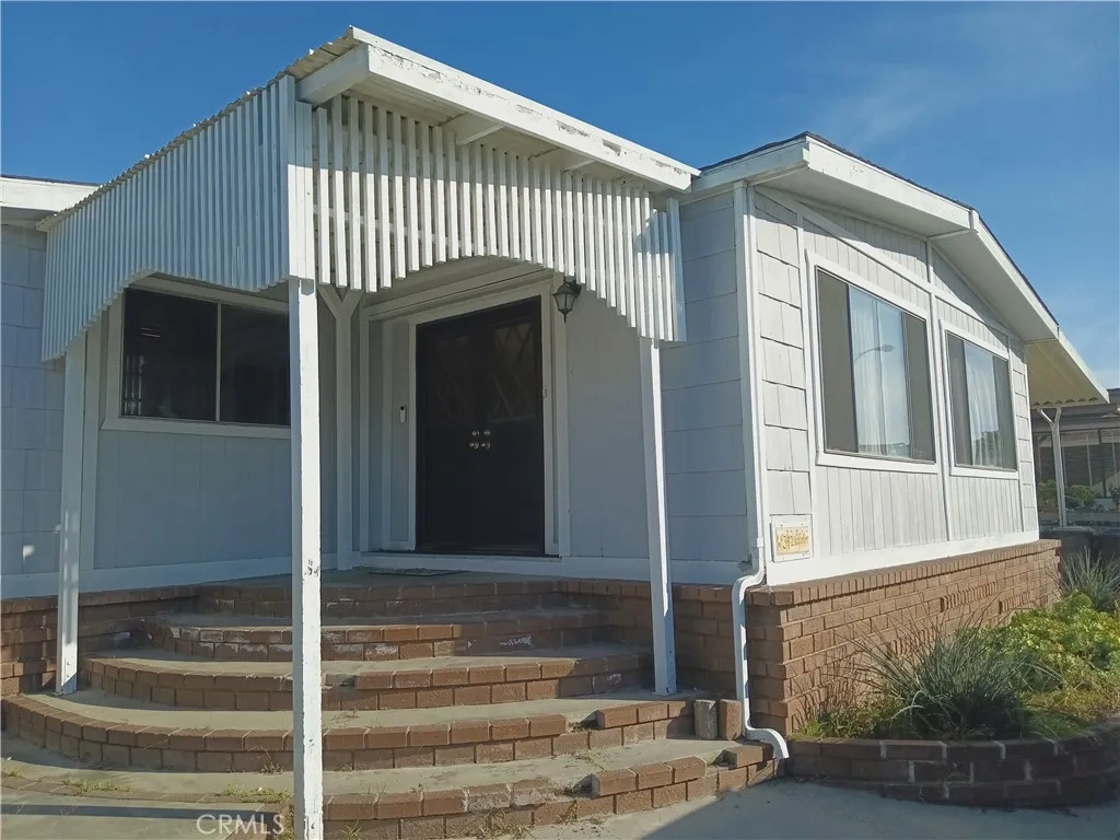 1000 East Victoria Street, Unit 342 Carson, CA 90746 - Photo 1 of 1 a front view of a house with entryway